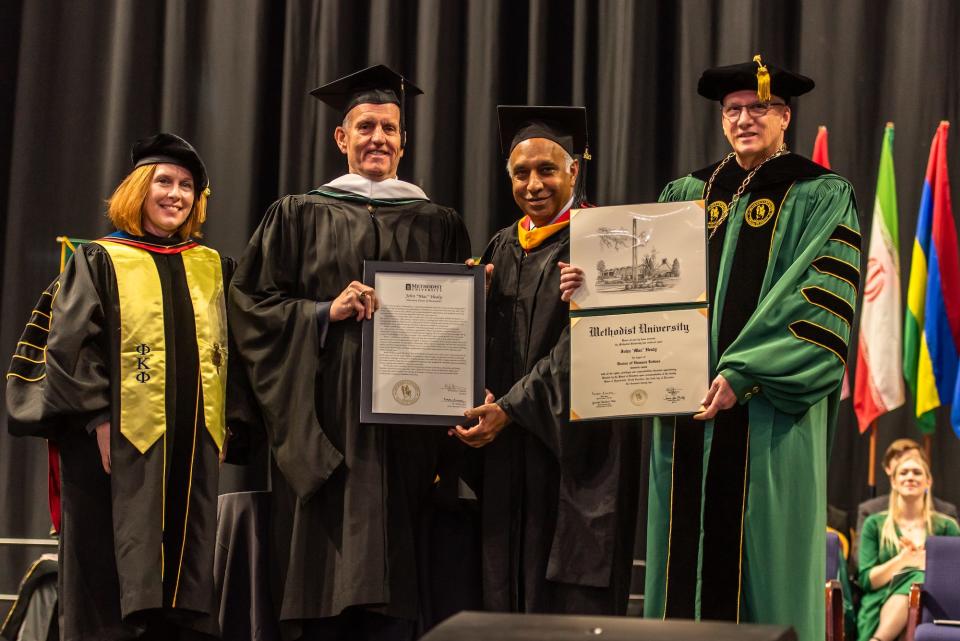 John “Mac” Healy, second from left, the Methodist University Board of Trustees’ immediate past chair, is presented with an honorary Doctorate of Humanities by Provost Dr. Suzanne Blum Malley, left, Board of Trustees Chair Dr. Rakesh Gupta, second from right, and President Stanley T. Wearden, right, on Saturday, Dec. 10, 2022.