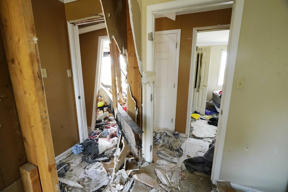 A mobile home frame, lower center, was blown by Friday's tornado into the Silver City, Miss., home of Robert "Rob" Lee, injuring his wife and himself, Tuesday, March 28, 2023. (AP Photo/Rogelio V. Solis)