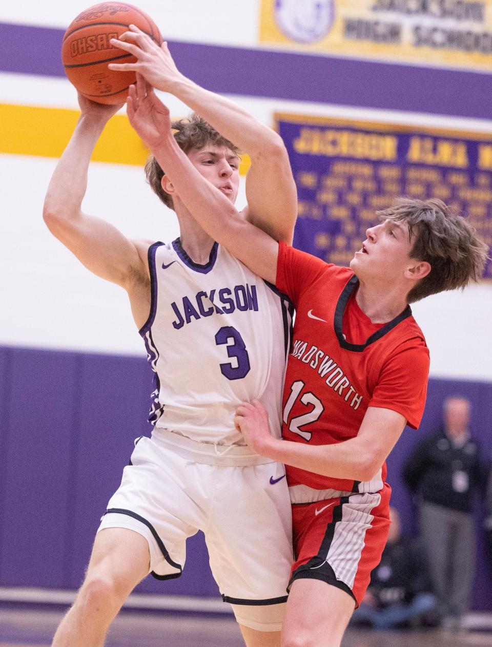 Jackson's Mitch Finefrock is guarded by Wadsworth's Grady Hughes in the first half at Jackson Tuesday, Feb.13, 2024.