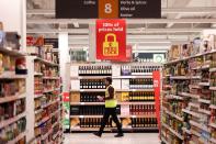 FILE PHOTO: A employee walks inside a Sainsbury’s supermarket in Richmond, west London