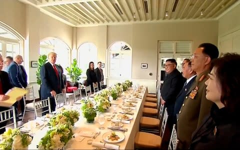 U.S. President Donald Trump, second from left, and North Korean leader Kim Jong Un, fourth from right, arrive for a working lunch at Capella Hotel  - Credit: AP