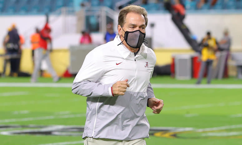 Nick Saban runs to the sideline.