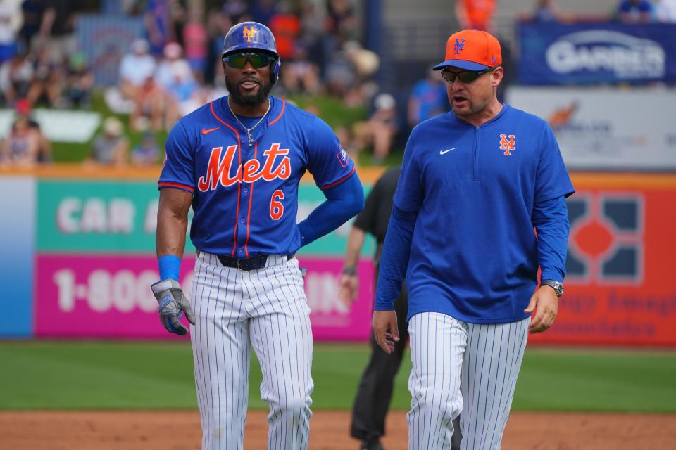 Mar 3, 2024; Port St. Lucie, Florida, USA; New York Mets right fielder Starling Marte (6) and manager Carlos Mendoza walk back to the dugout after Marte was called out for interference in the first inning against the Houston Astros at Clover Park.