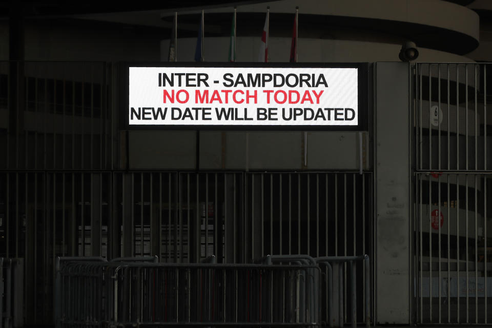 A notice outside San Siro stadium advises that the Serie A match between Inter and Sampdoria is cancelled, in Milan, Italy, Sunday, Feb. 23, 2020. In Lombardy, the hardest-hit region by the spread of the Coronavirus with 90 cases, schools and universities were ordered to stay closed in the coming days, and sporting events were canceled. Lombardy's ban on public events also extended to Masses in churches in the predominantly Roman Catholic nation. (AP Photo/Antonio Calanni)