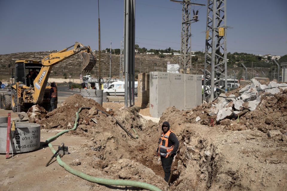 A road crew works on a project at Tapuah Junction in the West Bank, Thursday, Aug. 31, 2023. Israel's finance minister Bezalel Smotrich — a staunch supporter of settlements that most of the international community considers a breach of international law — assumed new powers from the military over the occupied territory this year. As the first minister to oversee civilian life in the West Bank, his role amounts to a recognition that Israel's occupation is not temporary, but permanent, observers say. (AP Photo/Maya Alleruzzo)