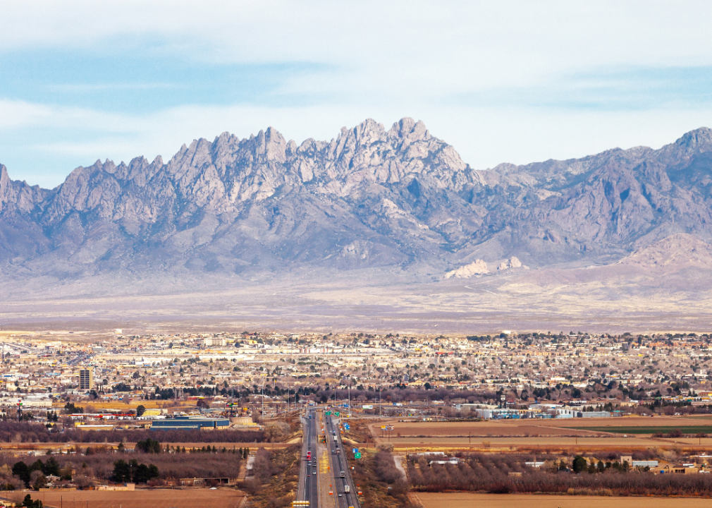 A view of a city with tall mountains in the background. 