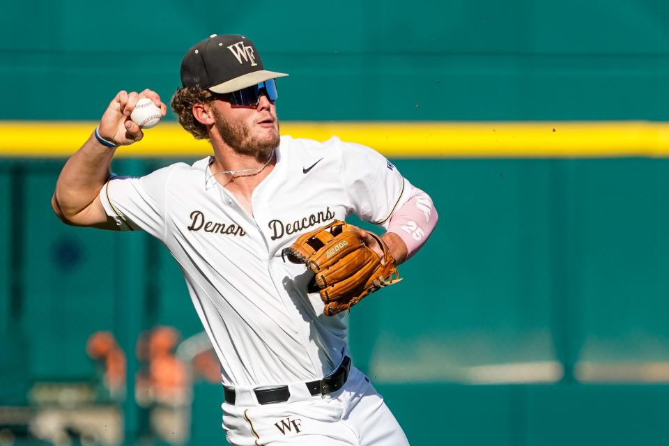 Jun 19, 2023; Omaha, NE, USA; Wake Forest Demon Deacons third baseman Brock Wilken (25) throws to get an out against the LSU Tigers during the first inning at Charles Schwab Field Omaha. Mandatory Credit: Dylan Widger-USA TODAY Sports