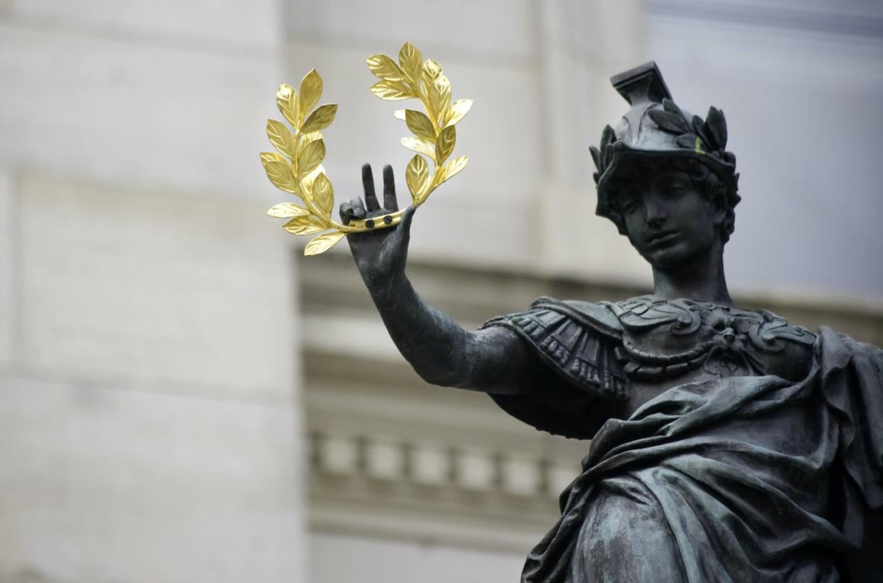 Laurel was an ancient symbol of medicine, the arts and the end of war. <a href="https://www.gettyimages.com/detail/photo/statue-holding-a-golden-laurel-royalty-free-image/157295503" rel="nofollow noopener" target="_blank" data-ylk="slk:naphtalina/E+ via Getty Images;elm:context_link;itc:0;sec:content-canvas" class="link ">naphtalina/E+ via Getty Images</a>