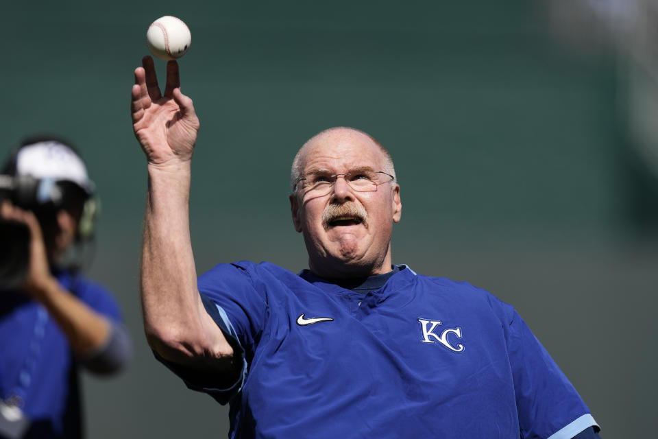 Kansas City Chiefs head coach Andy Reid throws out the first pitch before a baseball game between the Kansas City Royals and the Minnesota Twins Thursday, March 28, 2024, in Kansas City, Mo. (AP Photo/Charlie Riedel)