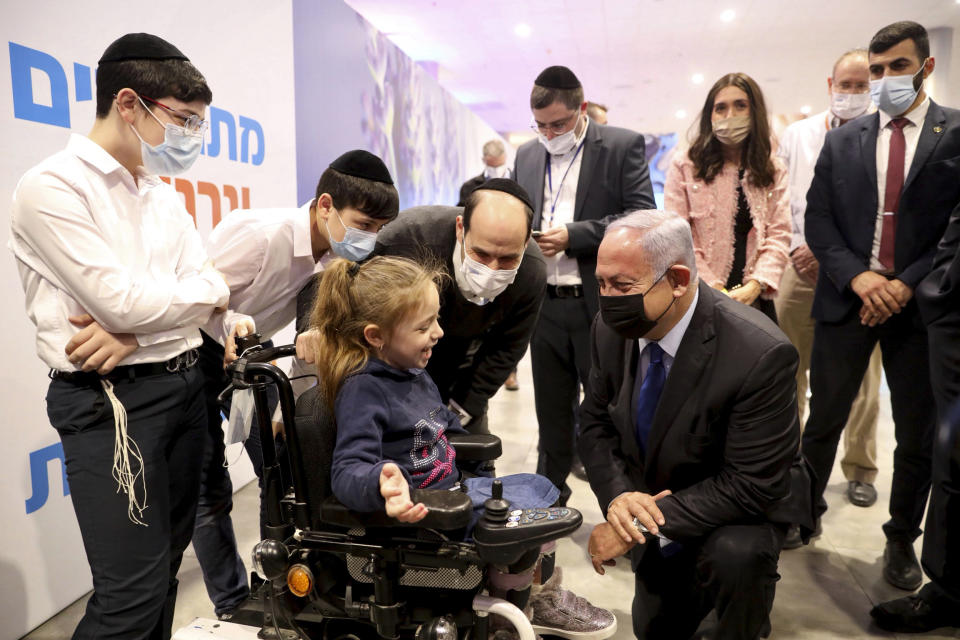 Israeli Prime Minister Benjamin Netanyahu, center right, visits an anti-coronavirus vaccination facility in Jerusalem, Wednesday, Jan. 6, 2021. (Marc Israel Sellem/Pool via AP)