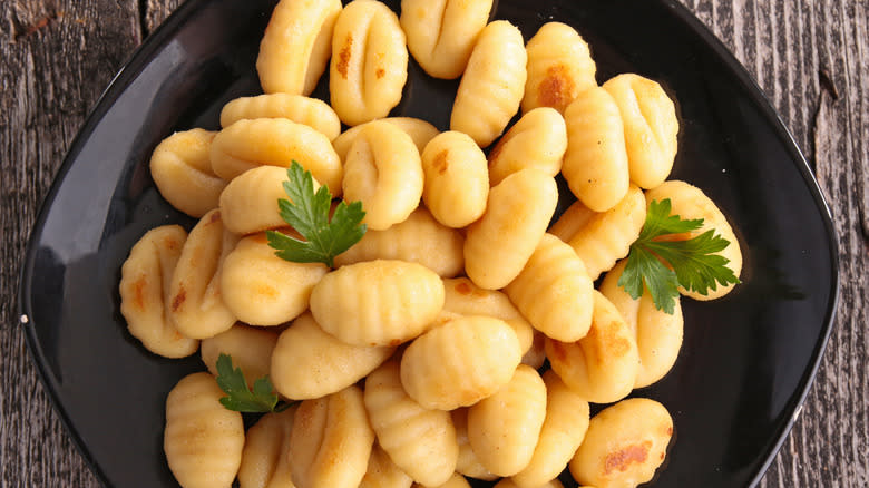 Gnocchi on plate with herbs