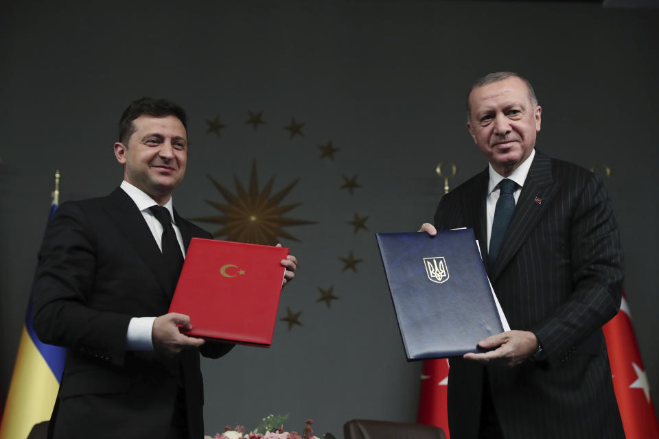 Turkish President Recep Tayyip Erdogan, right, and Ukrainian President Volodymyr Zelenskiy pose for photographs after they signed agreements, in Istanbul, Friday, Oct. 16, 2020. President Zelenskiy is in Istanbul for a one-day working visit. (Turkish Presidency via AP, Pool)