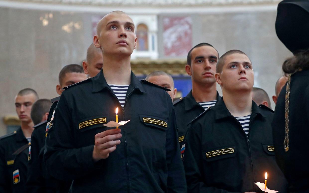 Sailors attend a memorial service at Kronshtadt Navy Cathedral for fourteen sailors who died - REX