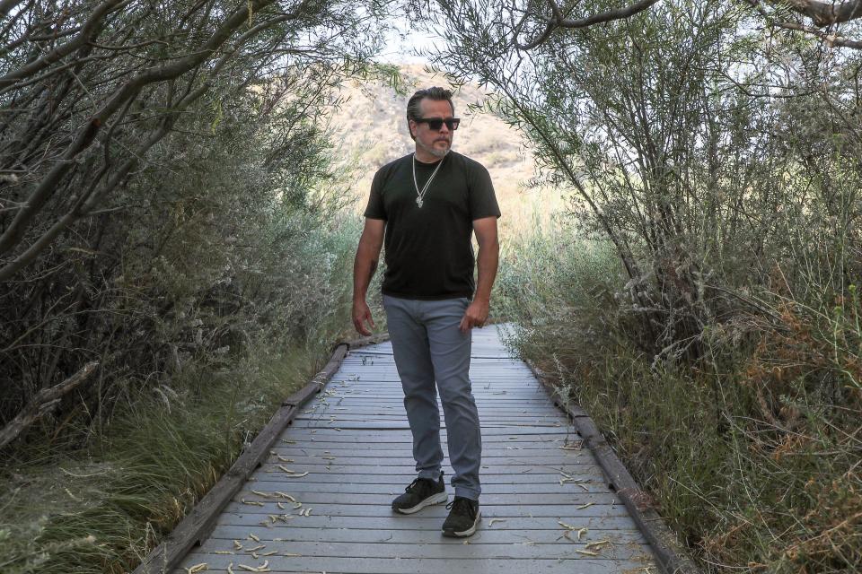 Musician John Garcia will be playing a benefit concert for Amy's Purpose, a nonprofit assisting people who have lost animals due to coyote and other predator attacks.  He is photographed at the Big Morongo Canyon Preserve in Morongo Valley, Calif., August 22, 2022. 