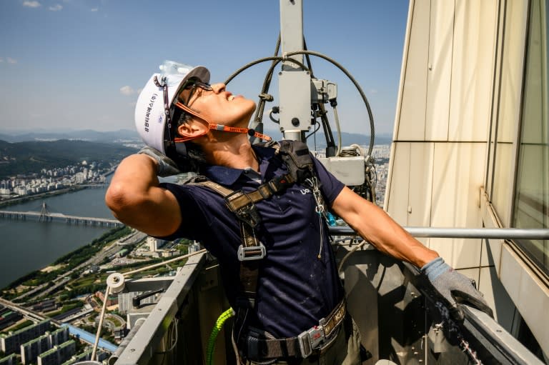 Seung-ho has for nearly thirty years cleaned the windows of the Lotte World Tower, South Korea's tallest building (Anthony WALLACE)