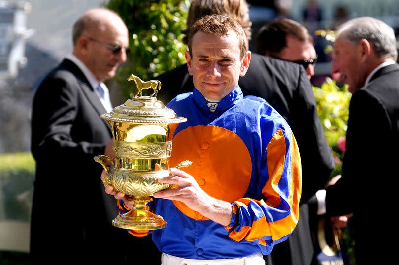 Jockey Ryan Moore celebrates with the trophy after winning the Prince Of Wales's Stakes on Auguste Rodin on day two of Royal Ascot 2024 at Ascot Racecourse on Wednesday, June 19 2024