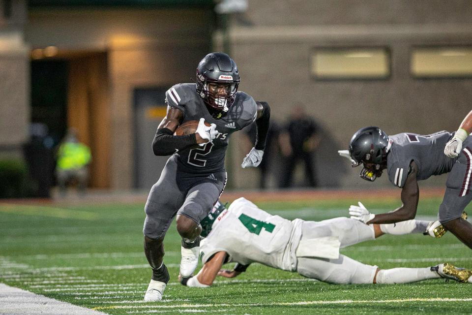 Benedictine’s wide receiver Thomas Blackshear breaks a tackle as he gains positive yards down the sideline