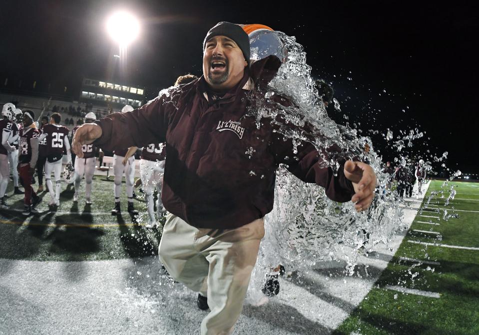 Aquinas head coach Derek Annechino is doused with water in the closing seconds of the Section V Class AA championship game at SUNY Brockport, Saturday, Nov. 3, 2018. Aquinas won the Class AA title with a 49-18 win over McQuaid.