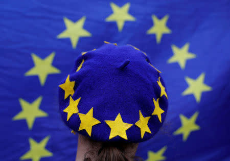 A protester wearing a Europen Union flag themed beret takes part in an anti-Brexit demonstration after Britain's Prime Minister Theresa May triggered the process by which the United Kingdom will leave the Euopean Union, in Birmingham, Britain. REUTERS/Darren Staples