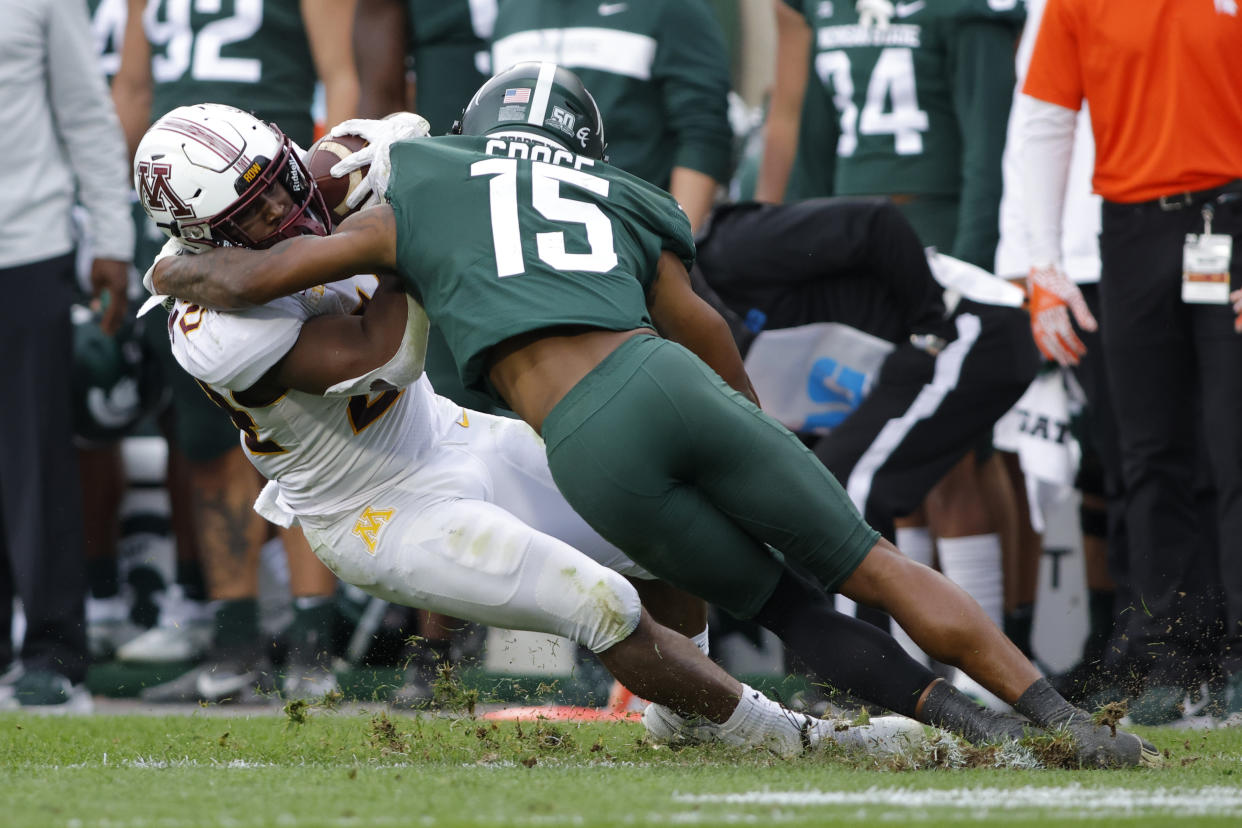 Minnesota's Mohamed Ibrahim, left, is tackled by Michigan State's Angelo Grose during the second quarter of an NCAA college football game, Saturday, Sept. 24, 2022, in East Lansing, Mich. (AP Photo/Al Goldis)