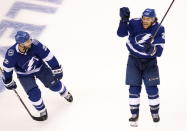 Tampa Bay Lightning center Brayden Point (21) celebrates his game winning goal against the Columbus Blue Jackets with teammate Kevin Shattenkirk (22) during the fifth overtime period in Game 1 of an NHL hockey Stanley Cup first-round playoff series, Tuesday, Aug. 11, 2020, in Toronto. (Frank Gunn/The Canadian Press via AP)