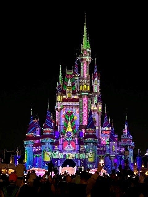 Cinderella Castle glows during a showing of "Frozen Holiday Surprise" at Walt Disney World's Magic Kingdom on Nov. 21, 2023.