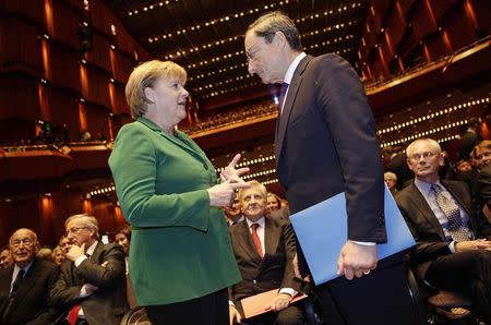 German Chancellor Angela Merkel (L) talks to new European Central Bank (ECB) President Mario Draghi prior to a farewell ceremony for outgoing ECB President Jean-Claude Trichet at the old opera house in Frankfurt, in this October 19, 2011 file photo. REUTERS/Kai Pfaffenbach/Files
