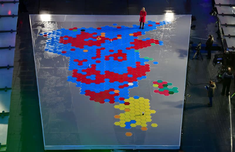 Presenter Sophie Raworth stands on the election result presented as a constituency map of the UK in Broadcasting House's piazza, in London