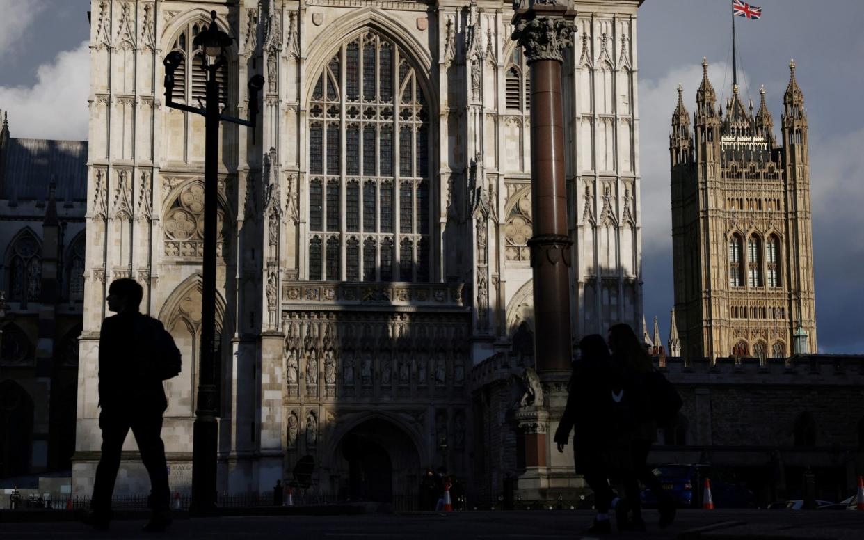 A person walks past Westminster Abbey - Henry Nicholls/Reuters