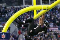 Wide receiver Torrey Smith #82 of the Baltimore Ravens hangs on the goal post after catching a touchdown pass during the first quarter against the New York Giants at M&T Bank Stadium on December 23, 2012 in Baltimore, Maryland. (Photo by Rob Carr/Getty Images)