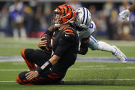 Cincinnati Bengals quarterback Joe Burrow (9) reacts to a late hit by Dallas Cowboys safety Donovan Wilson (6) after a scramble during the first half of an NFL football game Sunday, Sept. 18, 2022, in Arlington, Tx. (AP Photo/Tony Gutierrez)