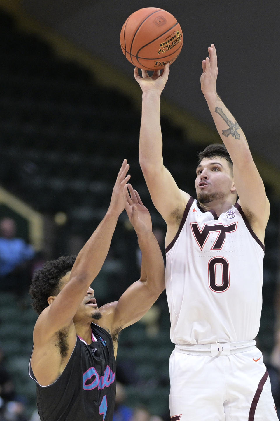 Virginia Tech guard Hunter Cattoor (0) shoots in front of Florida Atlantic guard Bryan Greenlee (4) during the first half of an NCAA college basketball game, Sunday, Nov. 26, 2023, in Kissimmee, Fla. (AP Photo/Phelan M. Ebenhack)
