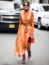 <p>Camila Coelho outside the Tibi show wearing a orange jumpsuit. <em>[Photo: Getty]</em> </p>