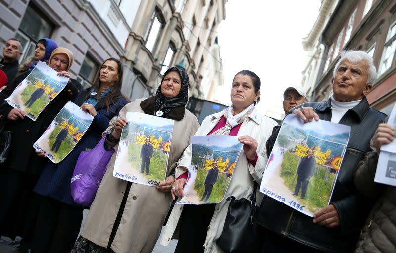 FILE PHOTO: Protesters from the Association of Victims and Witnesses of Genocide hold a picture of the winner of the 2019 Nobel Prize for Literature Peter Handke in Srebrenica, during a protest in front of Sweden embassy in Sarajevo, Bosnia