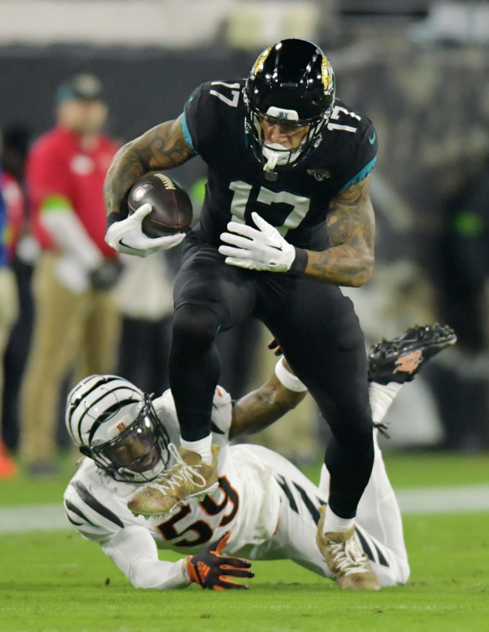 Jacksonville Jaguars tight end Evan Engram (17) sprints away from Cincinnati Bengals linebacker Akeem Davis-Gaither (59) on an early second quarter play. The Jacksonville Jaguars hosted the Cincinnati Bengals at EverBank Stadium in Jacksonville, Florida for Monday Night Football, December 4, 2023. The Jaguars were tied 14 to 14 at the end of the first half. [Bob Self/Florida Times-Union]