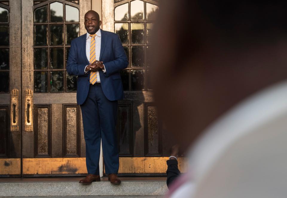 Principal Joseph Roberson greets community members as they welcome students at Lanier High School in Montgomery, Ala., on Wednesday, Sept. 14, 2022.