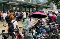 People protest to demand repayment of loans and financial products at the Evergrande's headquarters in Shenzhen