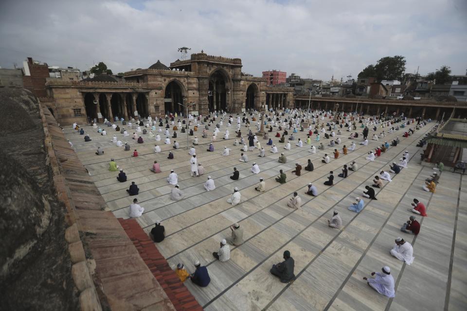 Indian Muslims sit while maintaining social distance and attend an Eid al-Adha prayer service at the Jama Masjid in Ahmedabad, India, Saturday, Aug. 1, 2020. Muslims worldwide marked the the Eid al-Adha holiday over the past days amid a global pandemic that has impacted nearly every aspect of this year's celebrations. (AP Photo/Ajit Solanki)