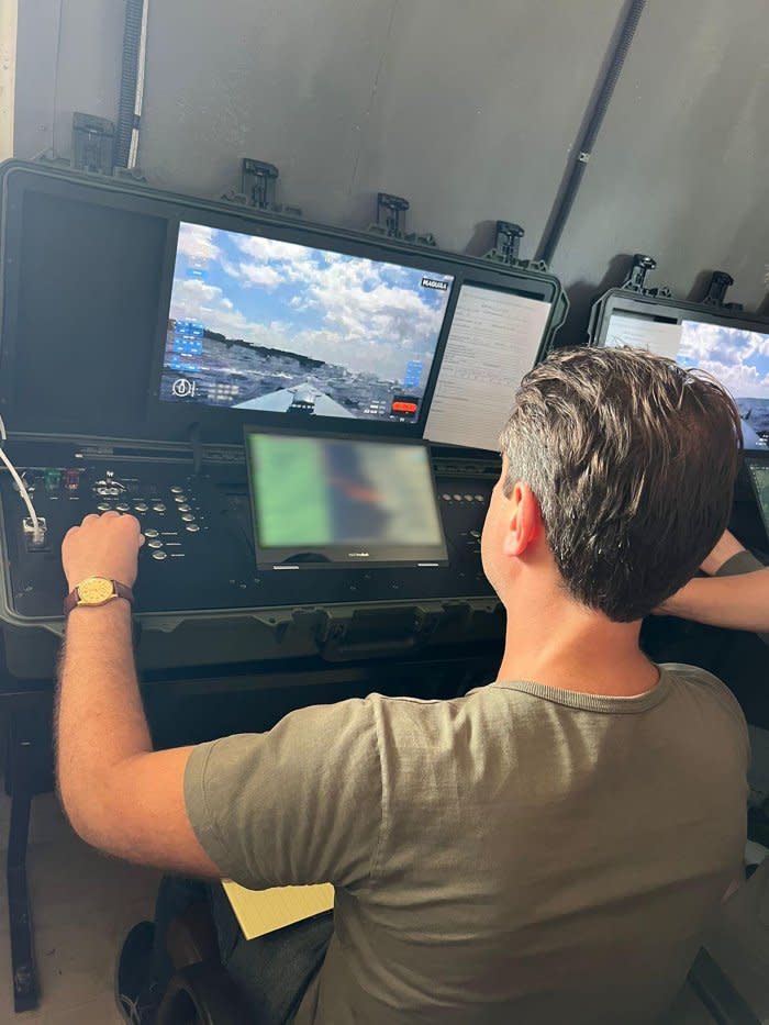 TIME correspondent Simon Shuster tries out the controls of a Magura naval drone at a clandestine military base in Ukraine. (A portion of this photograph was blurred due to security considerations)<span class="copyright">Courtesy the author</span>