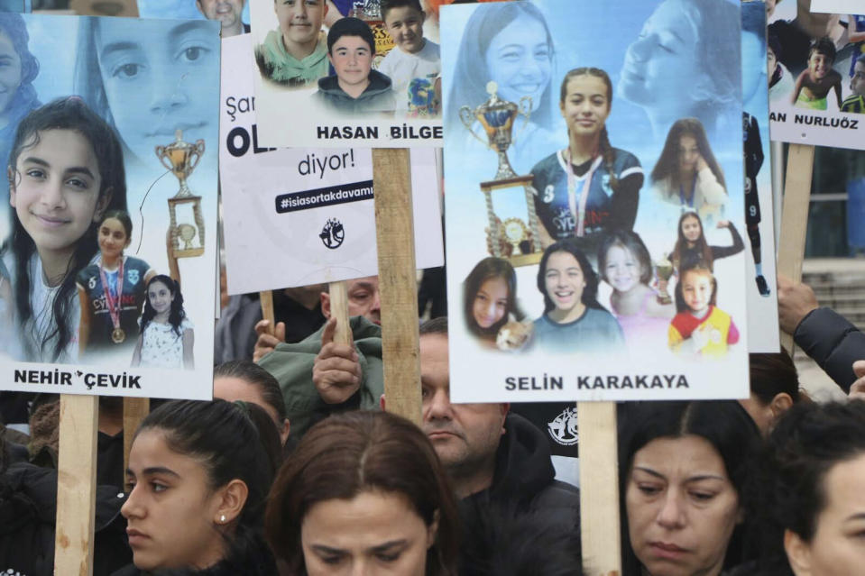 Relatives of the members of a school volleyball team killed in last year's earthquake gather outside the justice court during a trial in Adiyaman, southeastern Turkey, Wednesday, Jan. 3, 2024. Parents of the members of a school volleyball team that perished when their hotel crumbled in last year's powerful earthquake testified in the trial against the hotel's owner on Thursday, describing how hopes of finding their loved ones alive quickly turned to despair. (Dia Images via AP)