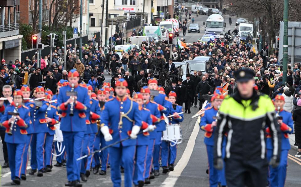 The funeral procession was led from central Dublin by a brass band and a single piper.