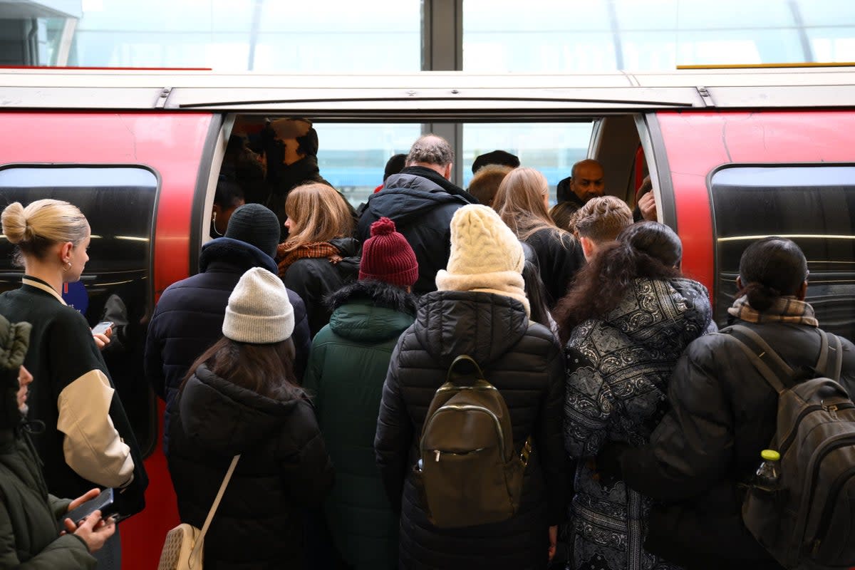 Commuters board a delayed Central Line train (Daniel Leal / AFP via Getty Images)