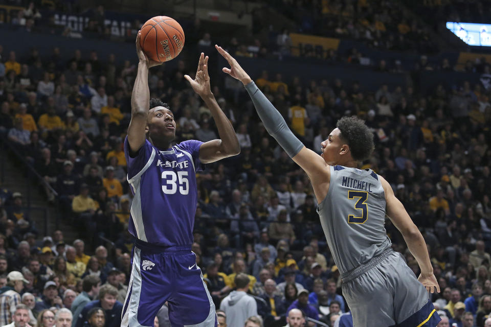 Kansas State forward Nae'Qwan Tomlin (35) shoots over West Virginia forward Tre Mitchell (3) during the first half of an NCAA college basketball game on Saturday, March 4, 2023, in Morgantown, W.Va. (AP Photo/Kathleen Batten)