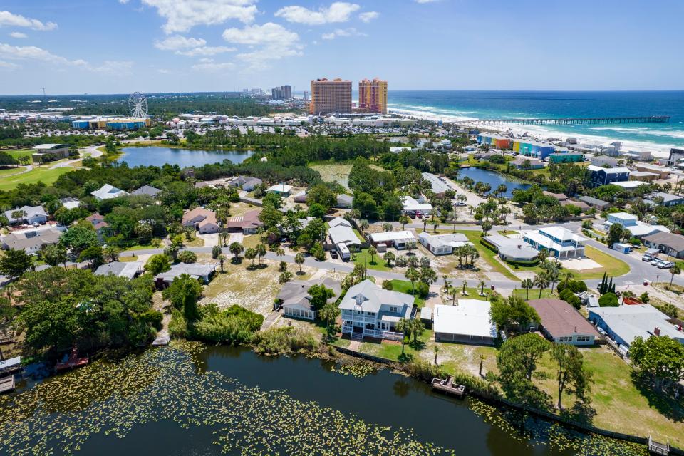 The $21 million project will combine current outfalls near Lullwater Lake, foreground, and Calypso Resort and Tower, channel the stormwater underground and deposit it about 1,500 feet into the Gulf.