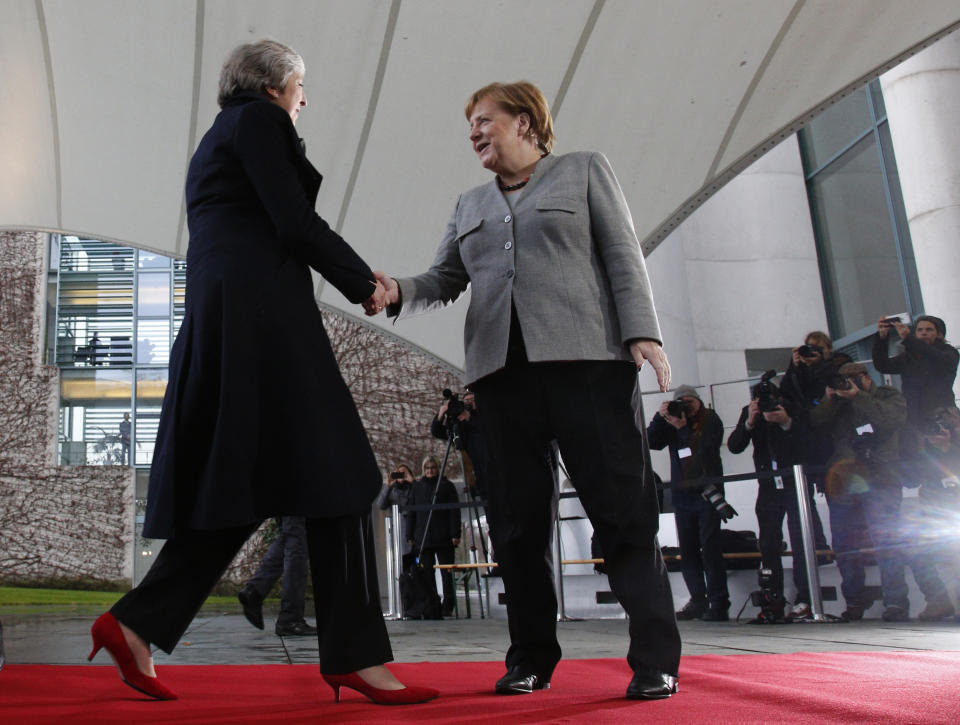 German Chancellor Angela Merkel, right, welcomes British Prime Minister Theresa May prior to a meeting in the chancellery in Berlin, Germany, Tuesday, Dec. 11, 2018. May is visiting several European countries to seek "assurances" on the Brexit agreement with the European Union to aid its passage through Britain's parliament. (AP Photo/Michael Sohn)