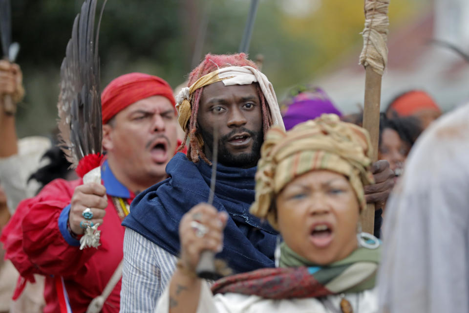 People participate in a performance artwork reenacting the largest slave rebellion in U.S. history in LaPlace, La., Friday, Nov. 8, 2019. The reenactment was conceived by Dread Scott, an artist who often tackles issues of racial oppression and injustice. Scott says that those who took part in the 1811 rebellion were "heroic" and that the rebellion is something that people should know about and be inspired by. (AP Photo/Gerald Herbert)