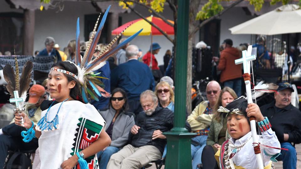 Members of a Native-American dance group from Tesuque Pueblo in New Mexico perform in the historic Plaza in Santa Fe, New Mexico, as part of the city's Indigenous Peoples Day program