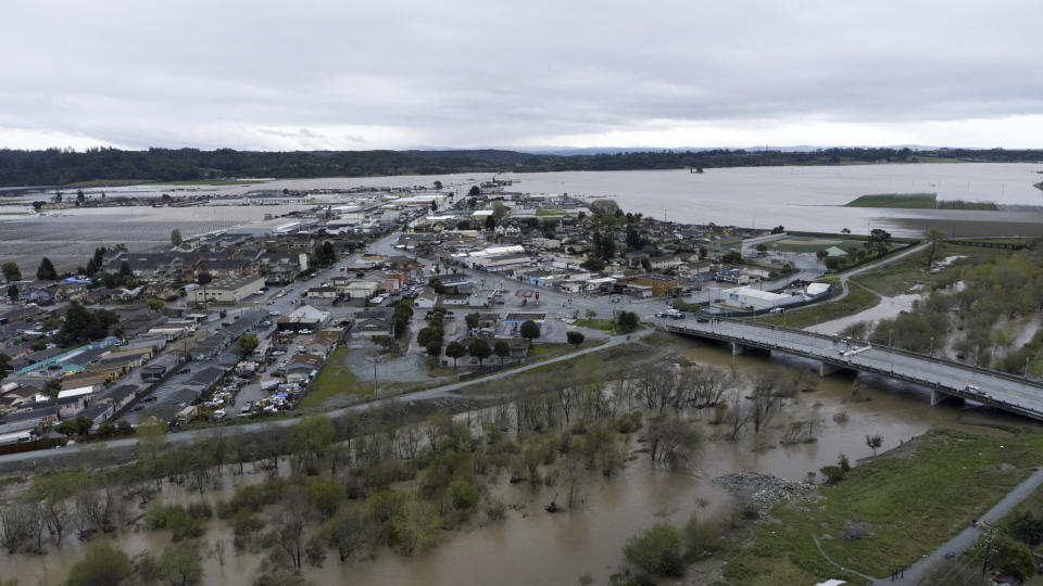 This photo provided by the California Strawberry Commission shows a flooded Pajaro River in Pajaro, Calif. on Tuesday, March 14, 2023. California's strawberry farms have been hit hard by this year's winter storms. Industry experts estimate about a fifth of strawberry farms in the Watsonville and Salinas areas have been flooded since a levee ruptured last week and another river overflowed. (California Strawberry Commission via AP)