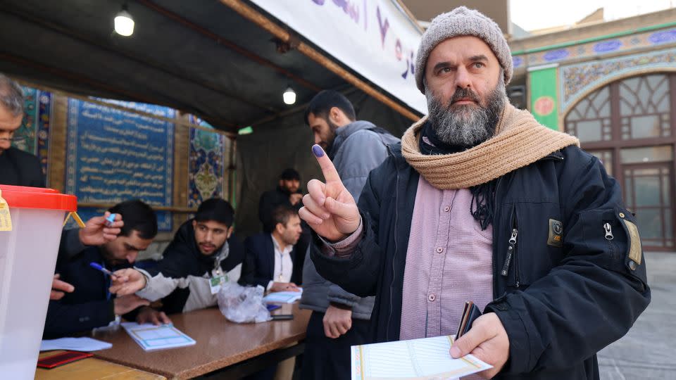 An Iranian man shows his ink-stained finger after casting her ballot, during elections to select members of parliament and the Assembly of Experts, in Tehran on Friday. - Atta Kenare/AFP/Getty Images