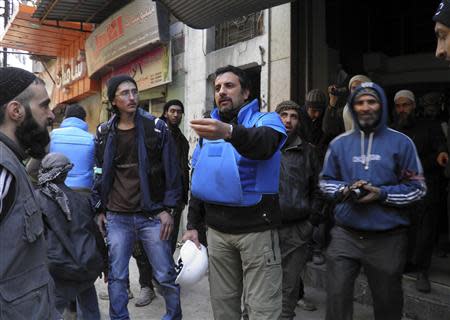 United Nations members arrive to the besieged neighbourhoods of Homs to supply humanitarian aid February 8, 2014. REUTERS/Thaer Al Khalidiya